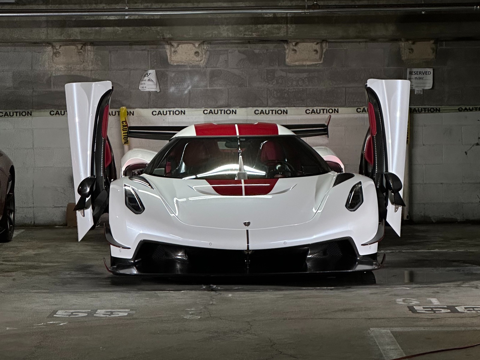 White hypercar with doors up in dark garage - Ascend Detail